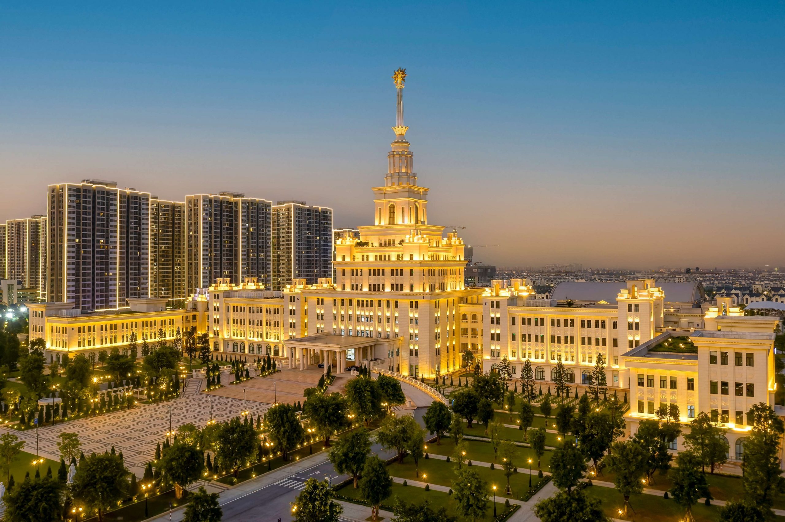 VinUni campus with its central tower and buildings illuminated at dusk